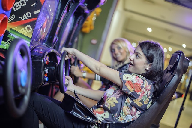 Girls playing driving game in arcade