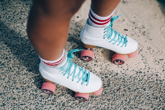 White roller skates with blue laces
