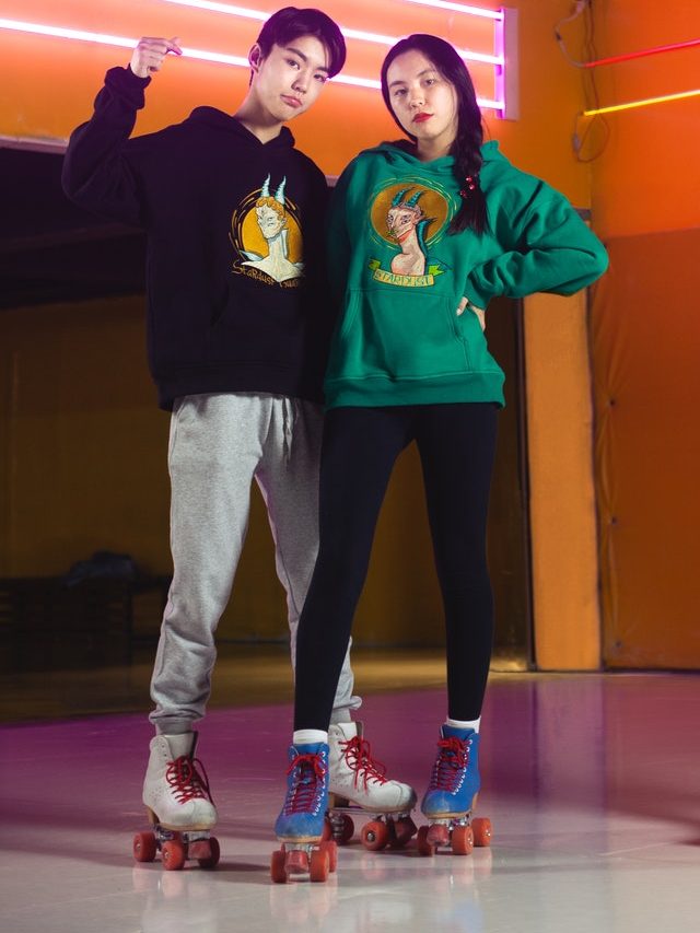 Couple standing in roller skates
